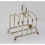 A FIVE BAR SILVER TOAST RACK raised on ball feet, Birmingham 1921, 77g