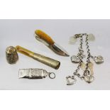 A SELECTION OF SILVER ITEMS, to include a shoe style pin cushion, a decorative whistle, a thimble, a