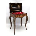 A CONTINENTAL INLAID VANITY FITTED BOX TOP TABLE, having profuse marquetry and applied cast gilt
