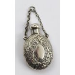 GEORGE UNITE A SILVER SCENT FLASK of oval form with screw cap and chain handle, embossed floral