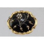 A VICTORIAN 18CT GOLD ONYX AND SEED PEARL MOURNING BROOCH, of floral design