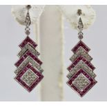 A PAIR OF ART DECO STYLE RHODIUM FINISHED WHITE GOLD COLOURED METAL RUBY AND DIAMOND DROP