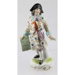 A SAMSON PORCELAIN FIGURINE of an 18th century Street Vendor, after the Chelsea Factory,