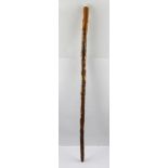 A WALKING CANE carved in the round with American figures in landscape, includes, Native American,