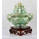 A CHINESE CARVED GREEN QUARTZ BOWL of two-handled censor form, raised on three feet with carved