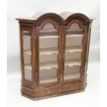 A 19TH CENTURY DUTCH OAK CABINET, having twin arched top with glazed doors, fitted two drawers to