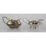 TWO SMALL SILVER MINT SAUCE JUGS, one plain Dublin 1912, the other of fluted Georgian design with