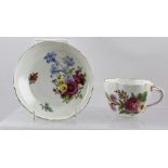 A 20TH CENTURY MEISSEN PORCELAIN CUP AND SAUCER decorated in polychrome with Deutsch Blumen