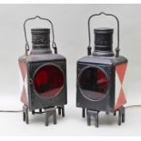 A PAIR OF EARLY TO MID 20TH CENTURY RAILWAY LANTERNS of metal construction, with carrying handles,