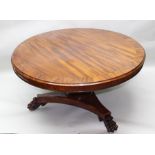 A 19TH CENTURY REGENCY DESIGN MAHOGANY DINING TABLE, having circular crossbanded top, raised on