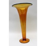 AN ART DECO AMBER GLASS TRUMPET VASE, having green rim and plain circular foot, 43cm high