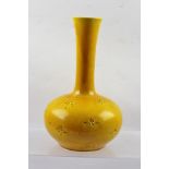 A LATE 19TH CENTURY POSSIBLY FRENCH VASE, having tapering neck on a squat base, yellow glaze with