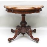 A VICTORIAN FIGURED WALNUT VENEER FOLDOVER CARD TABLE, having serpentine shaped edge, on turned