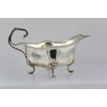 JOHN HENRY POTTER AN EDWARDIAN CREAM/SAUCE BOAT of Georgian design with gadrooned rim, raised on