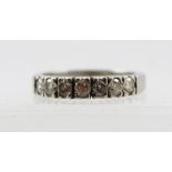 AN 18CT WHITE GOLD RING set with seven diamonds