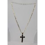 A VICTORIAN GOLD AND GARNET CROSS, on a later 9ct gold chain