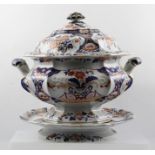 AN IRONSTONE IMARI PATTERN TWO-HANDLED TUREEN with cover, and a raised circular DISH, 30cm diameter