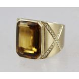 AN 18CT GOLD IMPERIAL TOPAZ AND DIAMOND RING, having tablet shaped topaz in plain mount, diamond