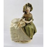 ROYAL DUX OF BOHEMIA A CERAMIC BOWL, upon the edge is modelled a girl in 19th century costume,