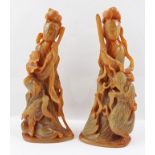 TWO CHINESE CARVED BUFFALO HORN SCULPTURES OF GUAN YIN, one with a raised sword standing over a