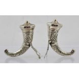 A PAIR OF NORWEGIAN STERLING SILVER CONDIMENTS in the form of Viking horn vessels with decorative
