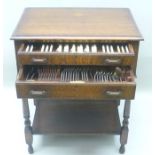 A "HARRODS LTD" OAK CANTEEN OF PLATED CUTLERY, the cabinet fitted two drawers (top drawer bears