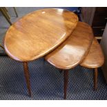 An Ercol nest of three tables with dark stain finish together with a pine chest of three drawers.