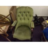 A large mahogany chair with green upholstery.