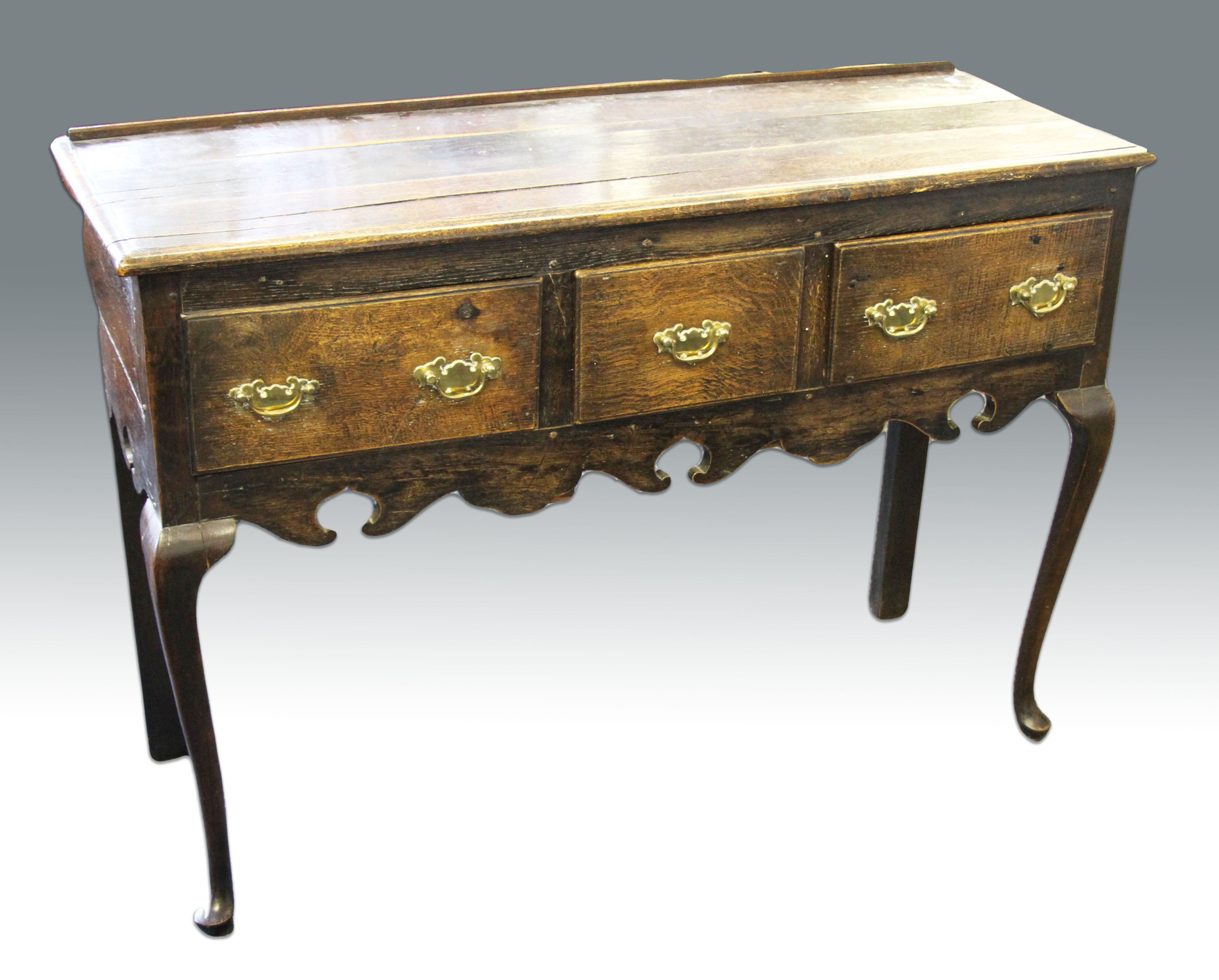An 18th Century oak dresser base with two long drawers to ends and short drawer to centre, with