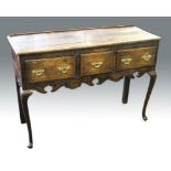 An 18th Century oak dresser base with two long drawers to ends and short drawer to centre, with