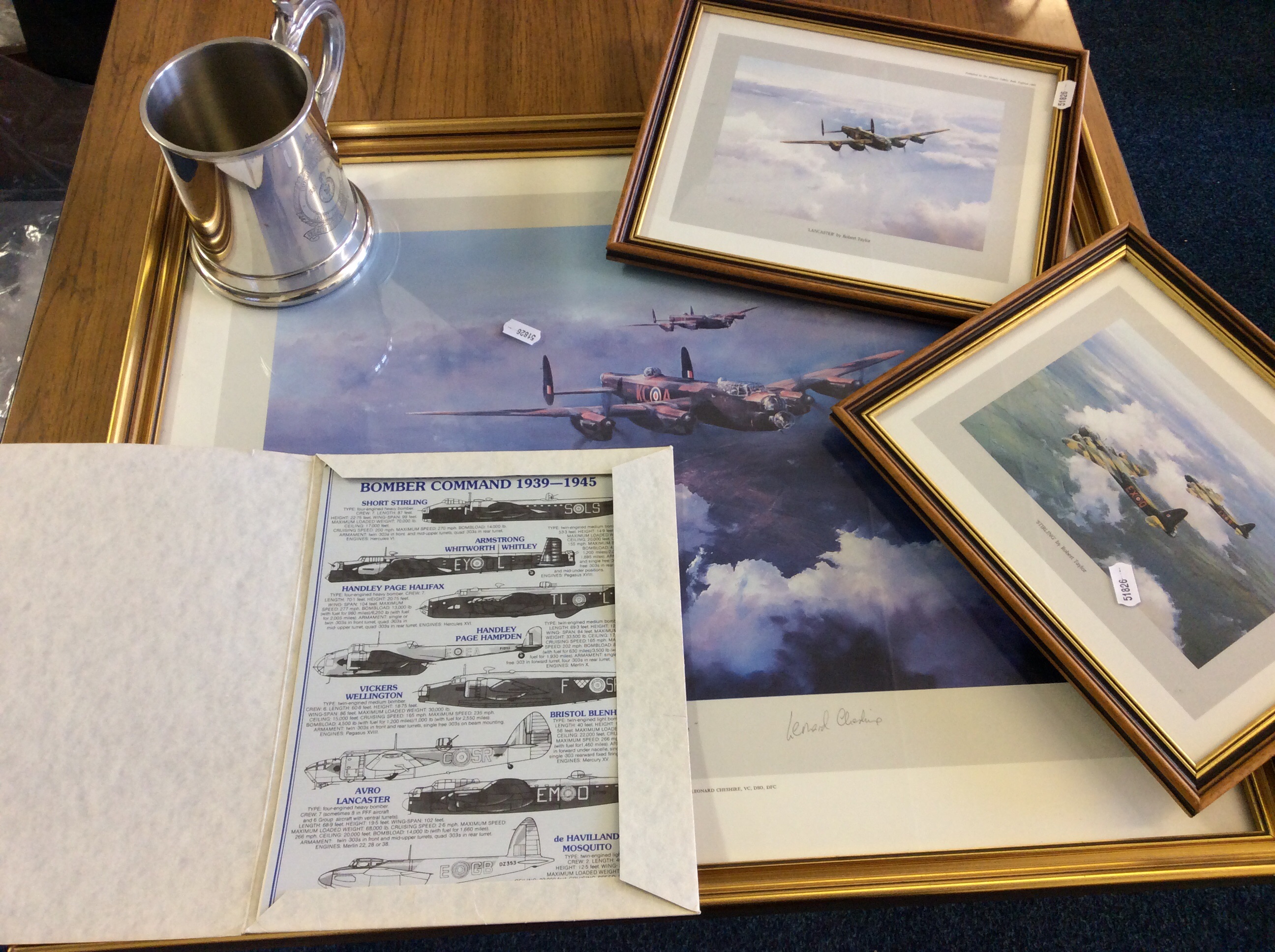 Three framed Royal Air Force bomber command pictures by Robert Taylor and folio along with a