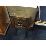 An oak hall table with fitted music box, with a pierced door and butterfly decoration inside.