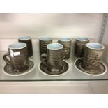 A set of seven ceramic St Ives tea cups with three plates.