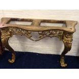 A decorative gilt console table with white marble top.