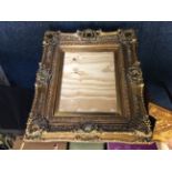 A reproduction gilt picture frame.