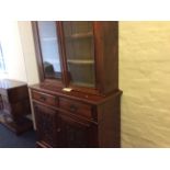 An Edwardian mahogany glazed topped bookcase with cupboard base.