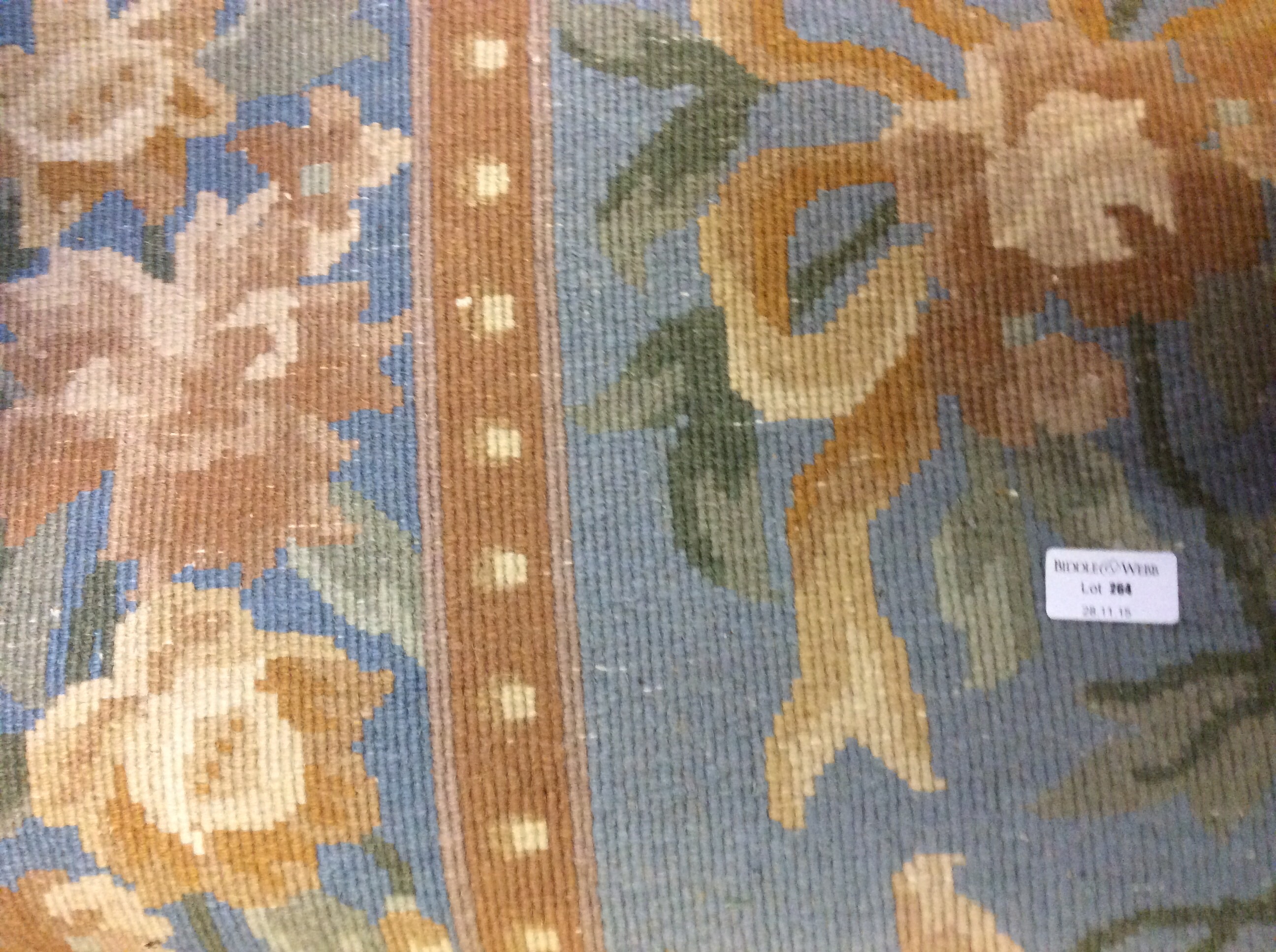 A blue and cream floral rug.