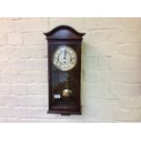 A Comitti of London wall clock with Westminister chime in mahogany case.