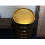 A large brass pot and a floral patterned brass tray.