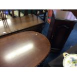 An oak table together with a mahogany cabinet with three drawers.