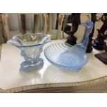 A blue moulded glass mermaid bowl together with a decorative vase.