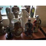 A set of five assorted oriental figurines and an oriental jug.