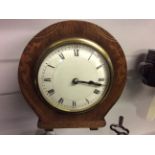 An inlaid wooden mantle clock.