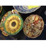 A set of green ceramic plates with sunflower design and an oriental dish.