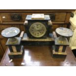 A Art Deco slate and marble mantle clock together with matching candle garnitures.