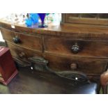 A Victorian mahogany veneered bow fronted chest of drawers with three long two short drawers.