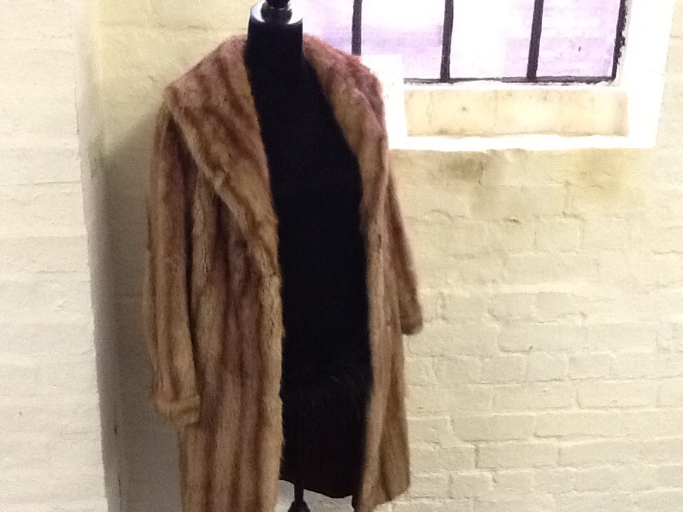 A ladies mink coat, with interior pocket.