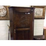 An oak hall cupboard with ship decoration together with an oak bedside table with drop leaf