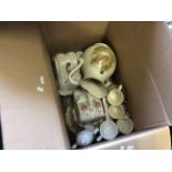 Two boxes of assorted ceramic ware and a fire blower.