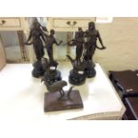 Four metal statuettes together with a bronze emu.